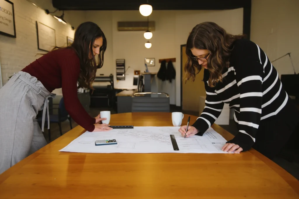 Alicia & Megan working together at design table